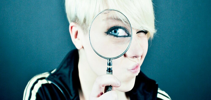 Woman looking Through Magnifying glass